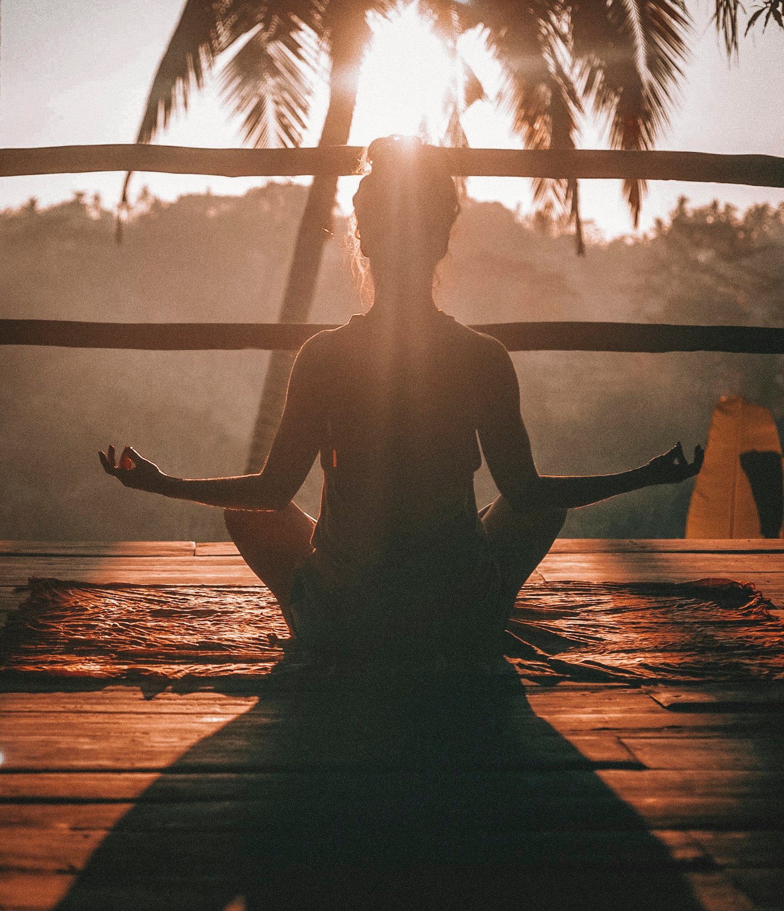 A person meditating in warm morning light